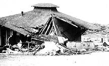 Image of a building destroyed by an earthquake.  This image links to a more detailed image.
