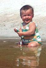 Image of a child playing in a creek.