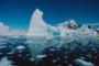 Image of some ice glaciers floating in water.