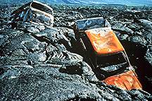 Image of two cars that were caught in a lava flow.  This image links to a more detailed image.