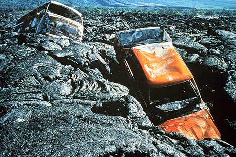 Image of two cars that were caught in a lava flow.
