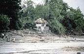 Image showing a house in the Philippines before a mudflow from Mt. Pinatubo.  This image links to a more detailed image.