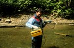 Image of Kenneth E. Rastall using a water quality meter.  This image links to a more detailed image.