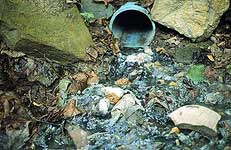 Image of raw sewage being piped directly into Wheeling Creek tributary.  This image links to the glossary page.